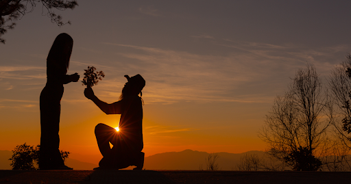 Young couple enjoying the sunset in the mountain